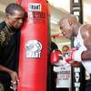 
Floyd Mayweather Sr., left, holds a heavy bag for his son Floyd Jr. during a workout Tuesday at the Mayweather Boxing Club. After a period of some tension between the two, the father is helping his son as a kind of informal adviser. "He doesn't have a name to what he is," Mayweather Jr. said. "He's just my father. He's there to support me."