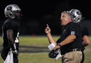 Palo Verde High football coach Darwin Rost with running back Tyrone Blake and quarterback Sean Mears (right) during the 2009 season.