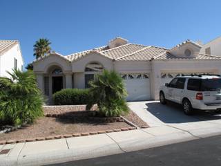A vehicle from the Clark County Coroner's Office is parked in the driveway Friday of a home at 1516 Willowbark Court, where authorities are investigating a murder-suicide that occurred a day earlier. 