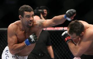 Vitor Belfort (blue) takes a swing at Rich Franklin (red) during UFC 103 at American Airlines Center in Dallas. Belfort defeated Franklin.