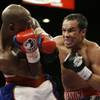 Floyd Mayweather Jr., left, is hit by Juan Manuel Marquez, of Mexico, during their non-title welterweight boxing match in Las Vegas. Floyd Mayweather Jr., left, is hit by Juan Manuel Marquez, of Mexico, during their non-title welterweight boxing match in Las Vegas.