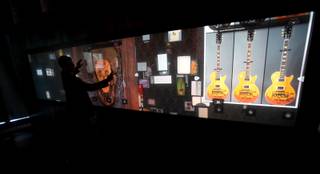 Joe Tenczar, senior director of technology at Hard Rock International, shows off the 18-by-4-foot interactive Rock Wall at the new Hard Rock Cafe on the Strip. 