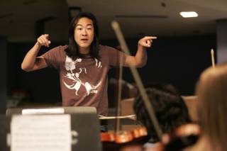 Alpin Hong, the city of Henderson's artist in residence, assists in an orchestra rehearsal at Basic High School Wednesday, Sept. 16, 2009. 