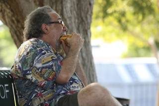 Henderson resident Jerry Laidman dives into a bratwurst smothered in vegetables Saturday afternoon during the 13th annual Wurstfest in Boulder City.