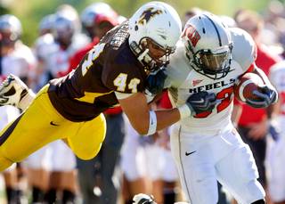 Wyoming defender Josh Biezuns (44) tackles UNLV running back Channing Trotter during Wyoming's 30-27 win Saturday in Laramie, Wyo.