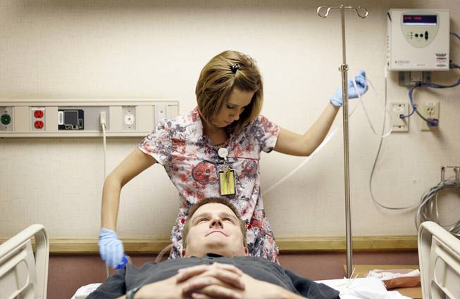 Amber Curl, a registered electroencephalographic and evoked potential technologist at Sunrise Hospital & Medical Center, gets ready to fit 21 electrodes onto Chris Stones head Monday, October 13, 2008. The electrodes will monitor Stones' brain activity, and his seizures will be induced to more accurately find the part of his brain where the seizures come from.