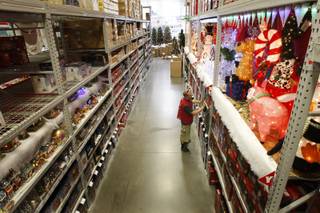 Customer service associate Jason White adjusts a display of Christmas merchandise at a Lowe's store in Henderson on Friday, Oct. 2, 2009. 