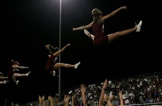 The Cimarron-Memorial cheerleaders perform for the home crowd during Thursday night's game against Legacy. Legacy eked out an overtime victory 30-29.  
