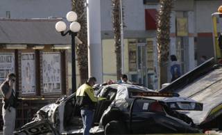 The police cruiser involved in a Wednesday night crash that left one officer dead and another seriously injured is shown Thursday morning at the intersection of Washington Avenue and Nellis Boulevard. 
