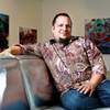 Photo: Todd VonBastiaans, sitting in his gallery/lighting