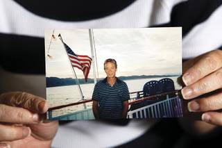 Mary Ann Reynolds holds a picture of her late husband, Robert, who had sought treatment for lower back pain. 