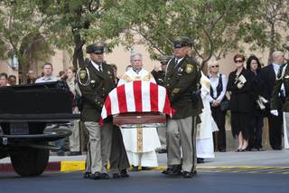 Honor guard members escort the casket of Metro Police Officer Milburn Beitel after his funeral Wednesday at Saint Elizabeth Ann Seton Roman Catholic Church in Las Vegas. Beitel died Oct. 8 at UMC hours after his cruiser crashed at Nellis Boulevard and Washington Avenue the previous evening.
