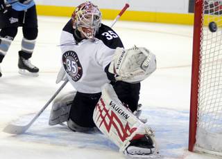 Wranglers goaltender Joel Gistedt deflects an Aces scoring attempt to the outside of the net during the first period of action at the Orleans Arena on Thursday night.