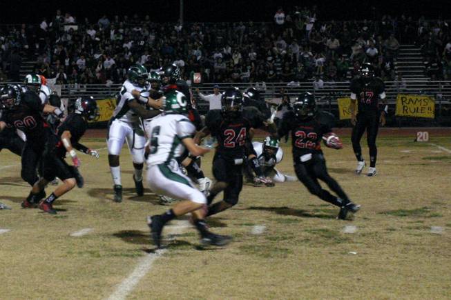 Michael Glenn (24) prepares to block for fellow Wildcat Cameron Rogers (22) during the first quarter of Thursday night's Bone Game against Rancho.