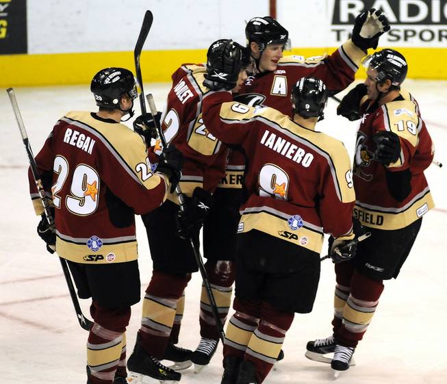 Bakersfield Condors come together in the second period to celebrate a power play goal scored by John de Gray (center) against the Wranglers on Thursday night.