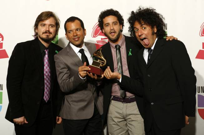 Members of Los Amigos Invisibles pose with their Grammy for Best Alternative Music Album at the 10th annual Latin Grammy Awards at the Mandalay Bay Events Center.