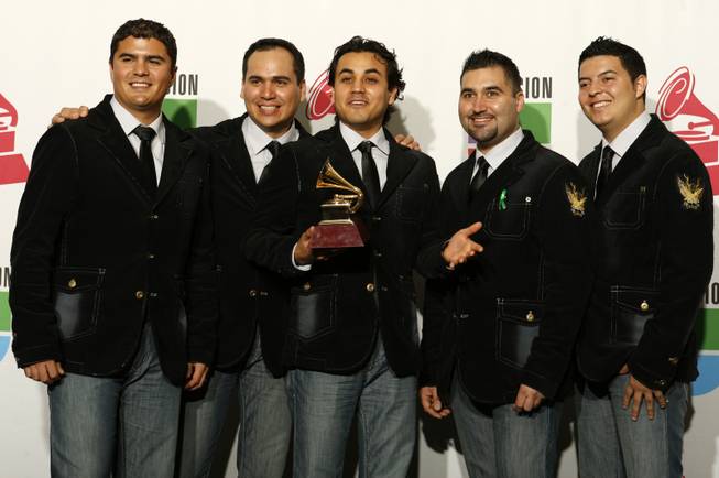 Members of the Mexican group Costumbre  pose with their Grammy for Best Norteno Album at the10th annual Latin Grammy Awards at the Mandalay Bay Events Center.