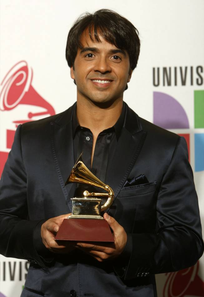 Luis Fonsi poses with the Grammy for Song of the Year at the 10th annual Latin Grammy Awards at the Mandalay Bay Events Center. The pair shared the award for "Aqui Estoy Yo" with Claudia Brant and Gen Rubin.