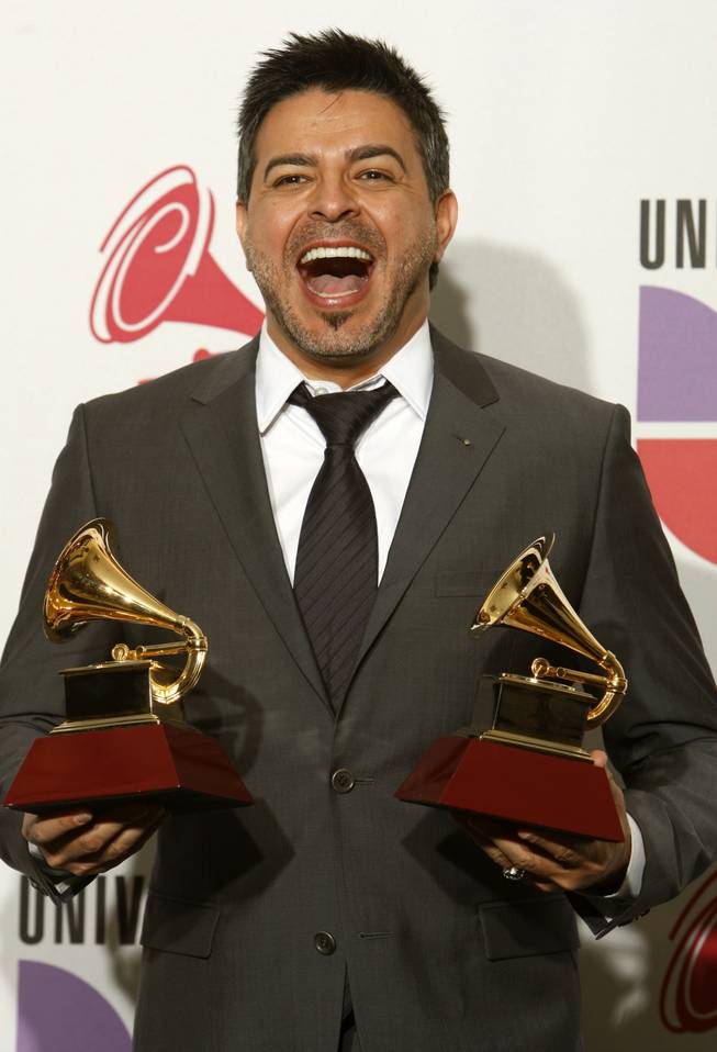 Luis Enrique poses with his awards at the 10th annual Latin Grammy Awards at the Mandalay Bay Events Center.