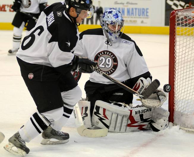 Wranglers defenseman Robbie Bina looks to control a Bakersfield shot deflected by goaltender Michael Ouzas during the first period of action on Thursday night.