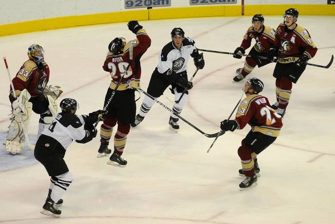 All eyes are on an airborne puck as Condors defenseman Eric Regan leaps to bat it away from his net during the second period of play at the Orleans Arena on Thursday night.