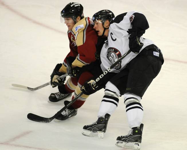 Las Vegas native and Bakersfield Condors forward Adam Naglich closely covers Wranglers center Chris Neiszner at the Orleans Arena Thursday night.