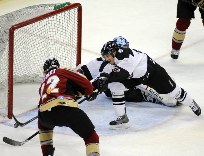 With netminder Michael Ouzas caught out of position while killing a five-on-three powerplay, Wranglers defenseman Robbie Bina robs Bakersfield's Stephane Goulet of an empty net goal during the first period of play on Friday night.