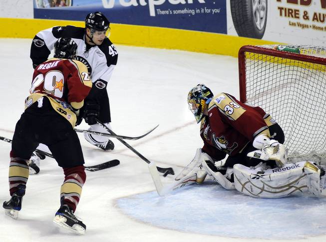 Wranglers right winger Ned Lukacevic drives toward Bakersfield goaltender Timo Pielmeier as defenseman Eric Regan closes in during the first period on Friday night.