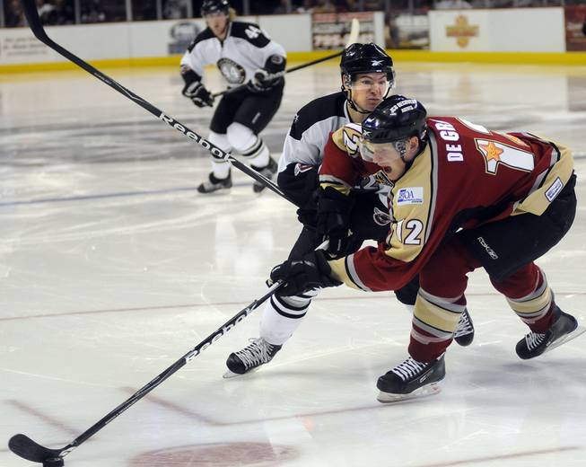 Wranglers center Chris Neiszner looks to shove Bakersfield defenseman John de Gray off the puck during the second period on Friday night.