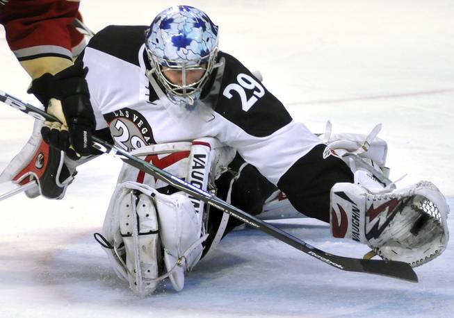 Seemingly beaten on the play, Wranglers goaltender Michael Ouzas flashes the leather to rip the puck right off the blade of the stick of Condors winger Stephane Goulet to preserve a 2-1 lead in the third period at the Orleans Arena on Friday night. Ouzas made 37 saves to improve his personal record to 5-2.