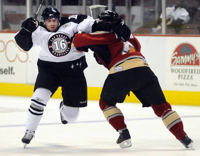 Las Vegas winger Matt Watkins attempts to drive around Bakersfield defenseman Shaun Fisher after dumping the puck into the zone during the second period on Friday night.