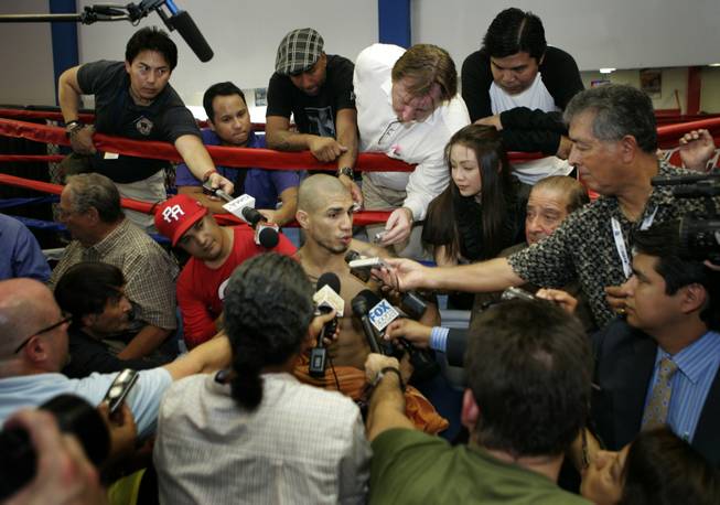 WBO welterweight champion Miguel Cotto of Puerto Rico is surrounded by reporters following a media workout at the Pound4Pound Gym in Los Angeles on Tuesday, Nov. 3, 2009. Cotto is scheduled to defend his title against Manny Pacquiao of the Philippines at the MGM Grand Garden Arena on Nov. 14. 