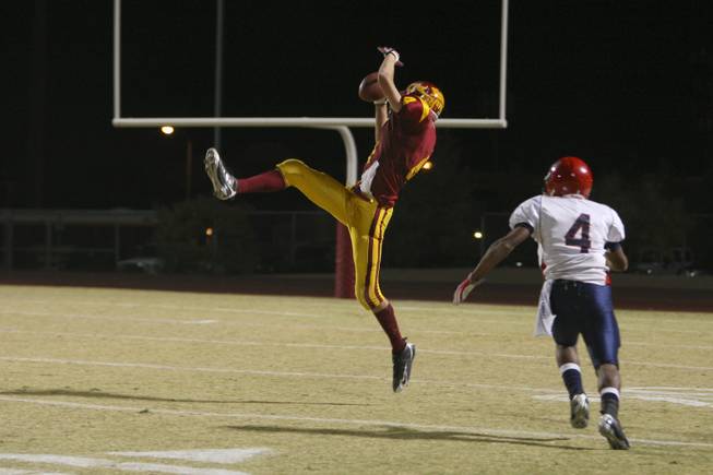 Del Sol wide receiver Evan Weinstock makes a catch above Coronado Devon Riley Friday night in the Dragons 46-26 victory to claim the Henderson-based Southeast Division title.