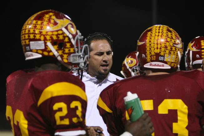 Del Sol head coach Preson Goroff talks with his team before the start of the second half Friday night in a 46-26 victory against Coronado. The win gives Del Sol the Southeast Division title.