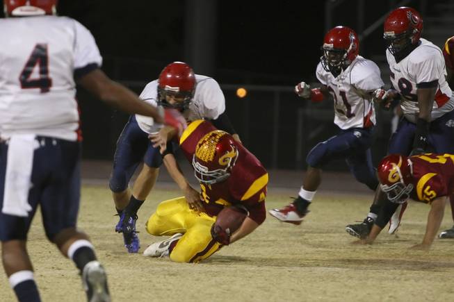 Del Sol linebacker Kip Canyon recovers a fumble by Coronado quarterback RJ Newton Friday night during Del Sol's 46-26 victory.