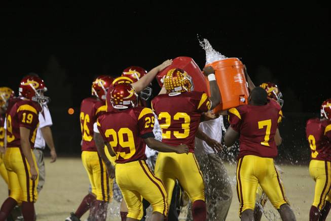Members of the Del Sol football team douses their coaches with water after winning the Henderson-based Southeast Division championship on Friday night.
