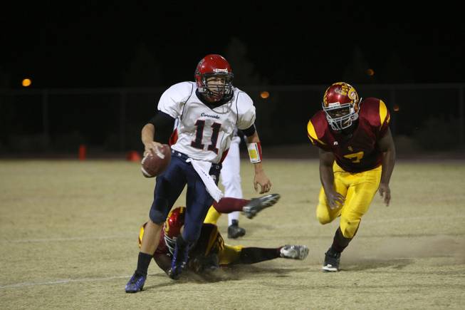 Coronado quarterback RJ Newton breaks a tackle as he carries the ball up field to score a touchdown in the first quarter against Del Sol Friday night. Coronado lost 46-26 as Del Sol clinched the Southeast Division title.