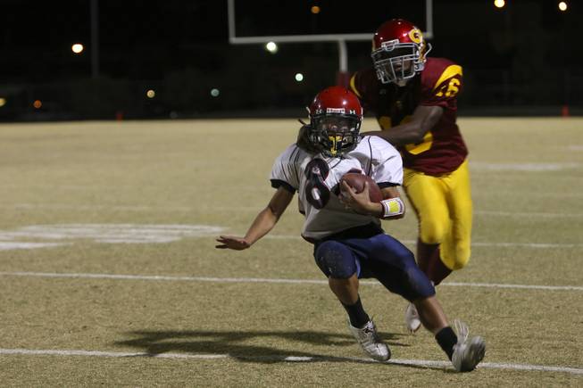 After a long gain, Coronado wide receiver Cody Mucino is tackled from behind by Del Sol defensive back Ashton Cacho Friday night in Del Sol's 46-26 victory to capture the league title in the Henderson-based Southeast Division.