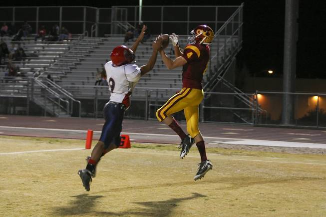 Del Sol wide receiver Evan Weinstock makes a catch in the end zone above Coronado defensive back Chris Johnson with 13 seconds to play before halftime to give the Dragons momentum for the second half. Weinstock finished with two touchdowns and the Dragons beat Coronado 46-26 to win the Southeast Division title.
