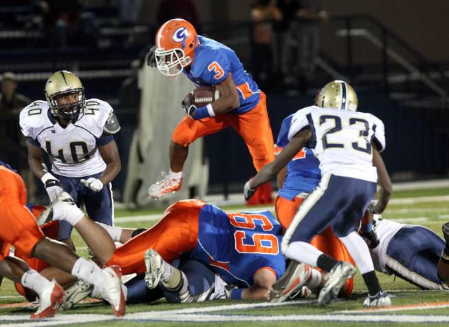 Bishop Gorman running back Shaquille Powell jumps over the Cheyenne Desert Shields line Friday night in the  Sunset Regional quarterfinals. Gorman dominated with a 56-15 victory.