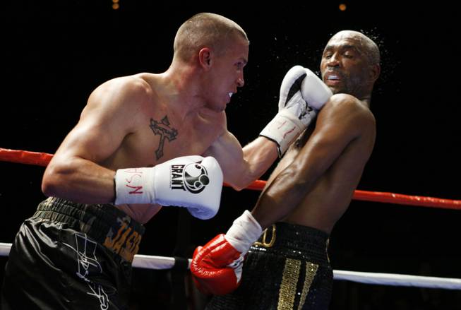 Former WBC lightweight champion Joel Casamayor, right, gets caught by an uppercut from Jason Davis during a eight-round super lightweight fight at The Pearl in The Palms Friday. Casamayor won the fight by unanimous decision.