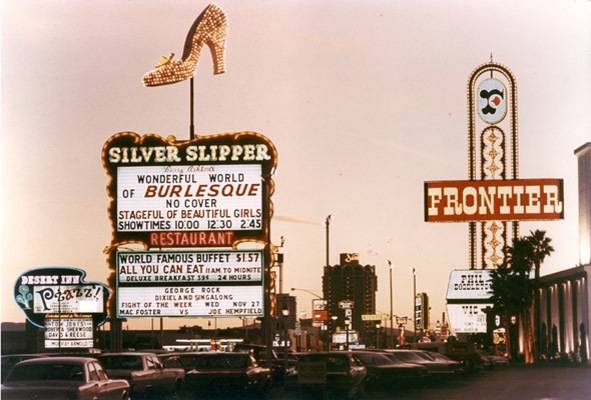 In this 1968 photo, the marquees of three Howard Hughes hotels light up at dusk. Rumors flew at the time that Hughes bought the Silver Slipper casino because he feared a camera was placed inside the toe of the shoe, which always stopped and faced his Desert Inn penthouse. After the casino's previous owners refused his repeated requests to turn off the shoe, Hughes bought it in 1968.