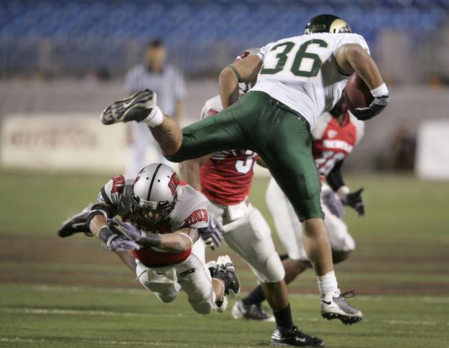 Colorado State fullback Zac Pauga hurdles over UNLV defensive back Terrance Lee during the first half of Saturday's game at Sam Boyd Stadium.