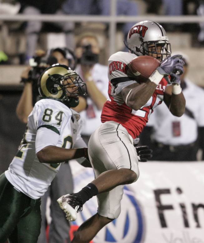 UNLV defensive back Mike Grant drops a pass intended for Colorado State wide receiver Rashaun Greer during the first half of Saturday's game at Sam Boyd Stadium.