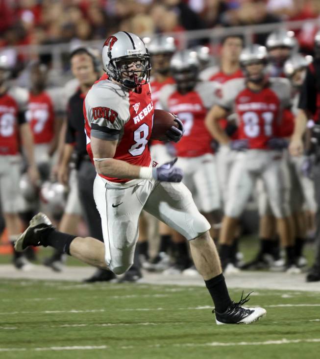 Ryan Wolfe of UNLV gets big yards on a reception during the game against Colorado St. at Sam Boyd Stadium Saturday. UNLV came out on top 35-16..