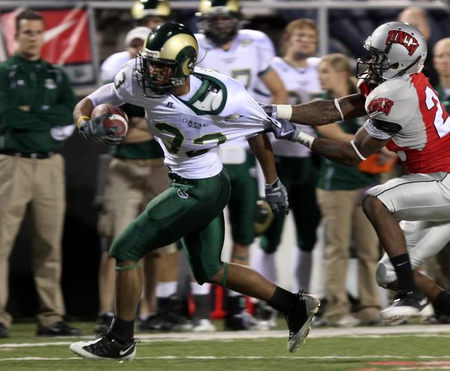 Colorado St. running back Lou Greenwood gets away from the Alex De Giacomo during the game at Sam Boyd Stadium Saturday.  UNLV came out on top 35-16..