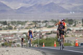 Richard McKeown of Henderson takes a drink of water after reaching the top of a hill on Horizon Ridge Parkway while participating in the 5th Annual Silverman Triathlon in Henderson on Sunday.