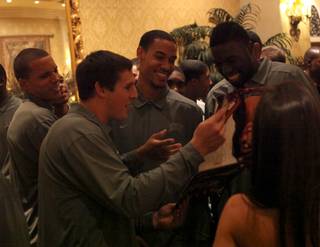 Current members of the UNLV basketball team check out themselves in the new Rebels calendar during a gala event Monday at the Green Valley Ranch in Henderson celebrating the 20-year anniversary of the 1989-90 squad's championship run.