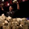 Joe Cada, 21, holds up some of his $8.5 million winnings after beating Darvin Moon in the final round of the 2009 World Series of Poker tournament early Tuesday at the Rio.

