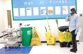 Head custodian Lori Scott gets her supplies ready to clean up during and after first-period lunch on the campus of Roy Martin Middle School in Las Vegas Tuesday, Nov. 10, 2009. 